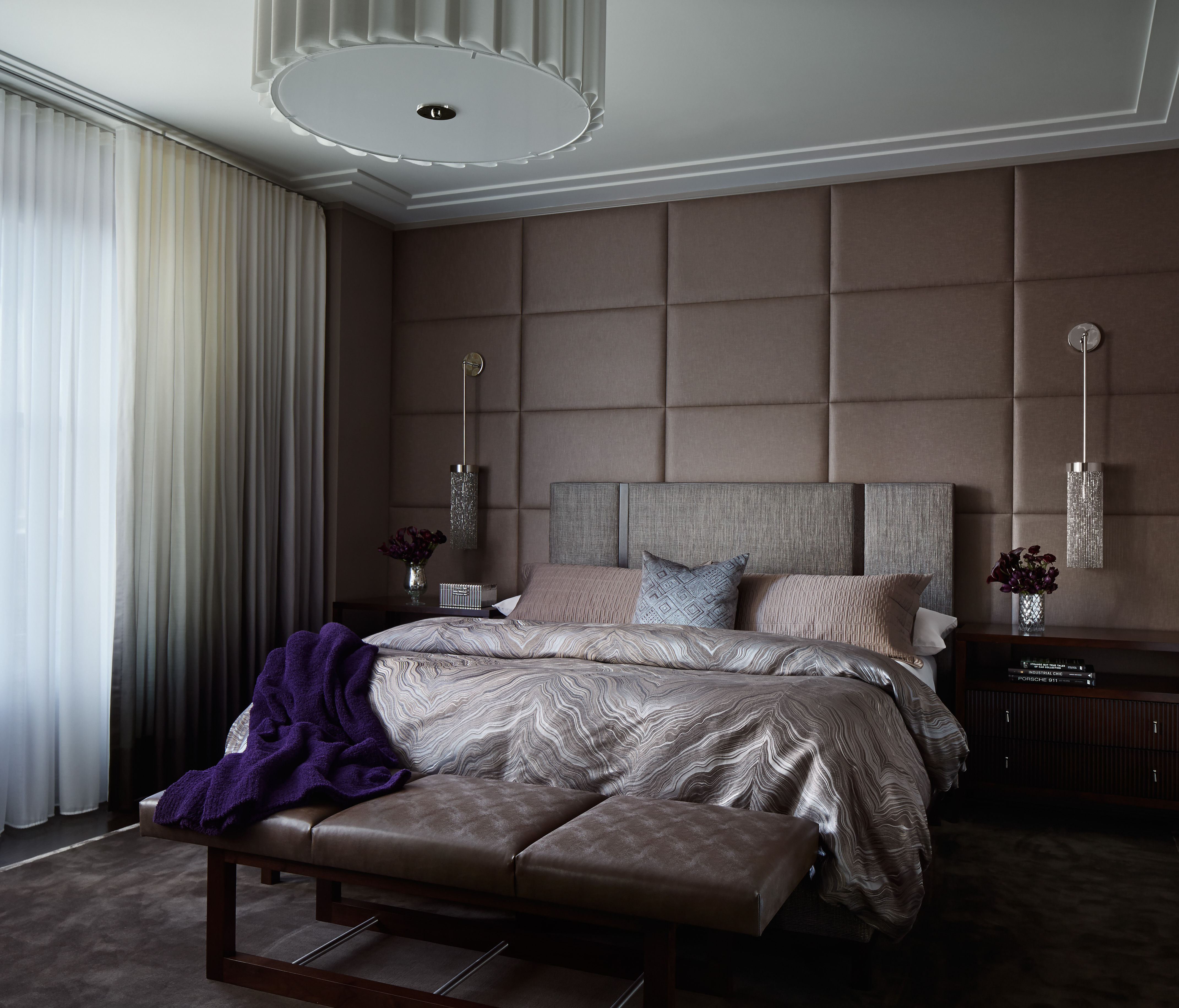 Dark and Mysterious Master Bedroom incorporates panelled walls, silk bedsheets, and sheer curtains