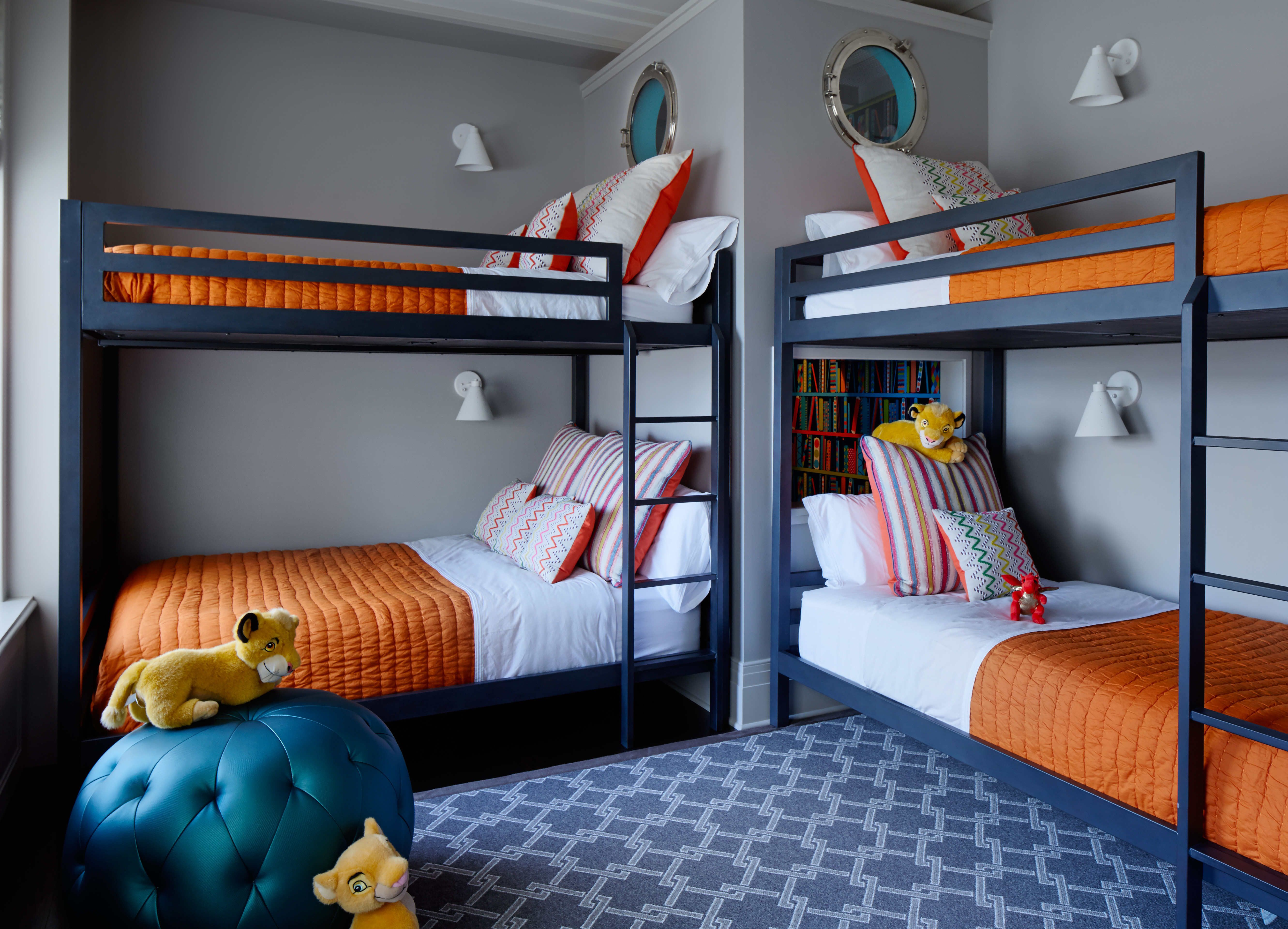 Bright Kids Bunk Room incorporating Double Bunk Beds with Orange Comofortors, and Teal Blue Pouf