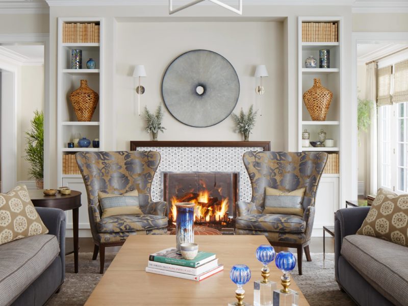 Bright and airy Living Room designed by Soucie Horner incorporates Fanback Wingchair from Edward Ferrel and Lewis Mittman using Anthony Inc Upholstery, William H Jackson Company Firescreen, and Wall-mount sconce from Urban Electric