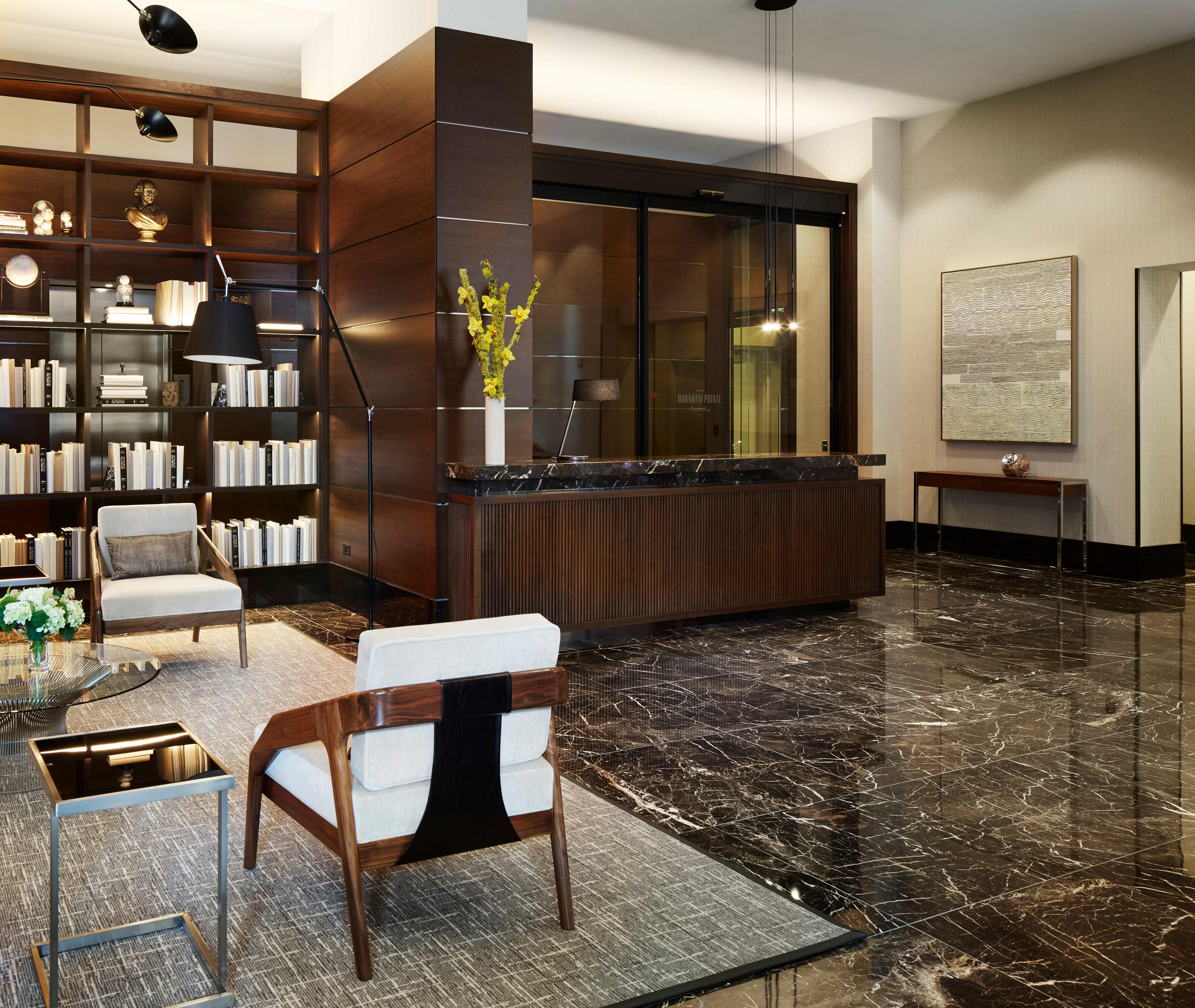Burnham Pointe Lobby transformed by Commercial Interior Designer and Architects and Soucie Horner, incorporating Platner Coffee Table from Knoll Studio, Belle Meade Hospitality Lounge Chairs using Pindler and Pindler upholstery, and custom banquette.