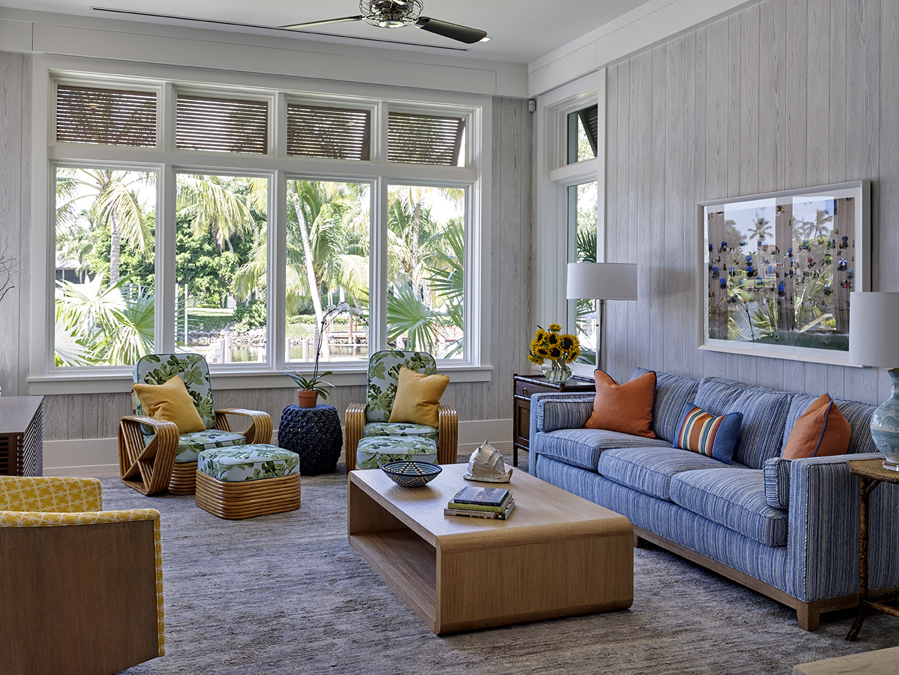 Modern coastal vibes take over Lanai Room, incorporating 1940's Rattan wrapped lounge chairs, ottomans, and tables from Midland Antiques.