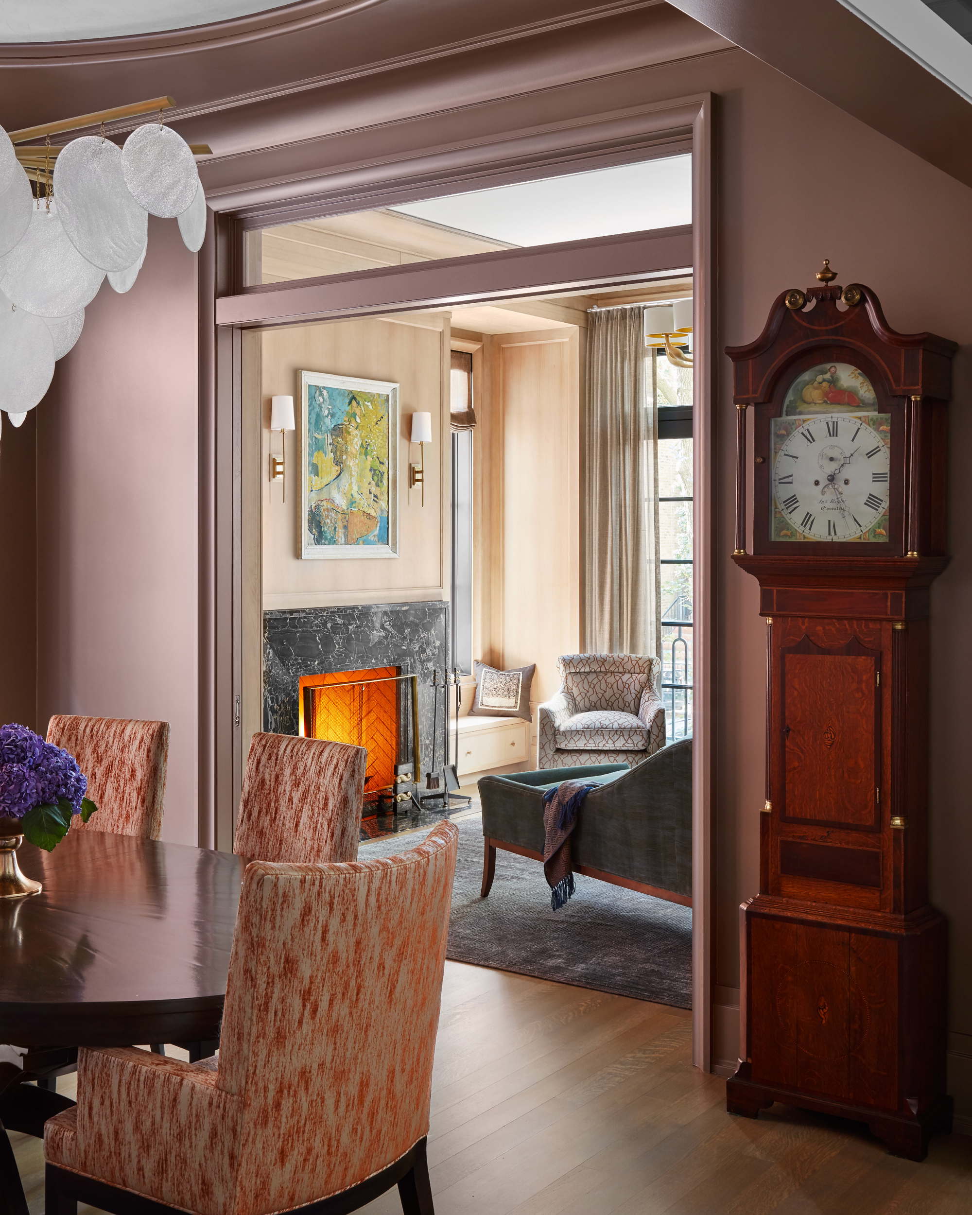 Feminine Dining Room incorporates A. Rudin Dining Chairs with Donghia upholstery, Grandfather Clock, and Nimbus Pendant via CTO Lighting