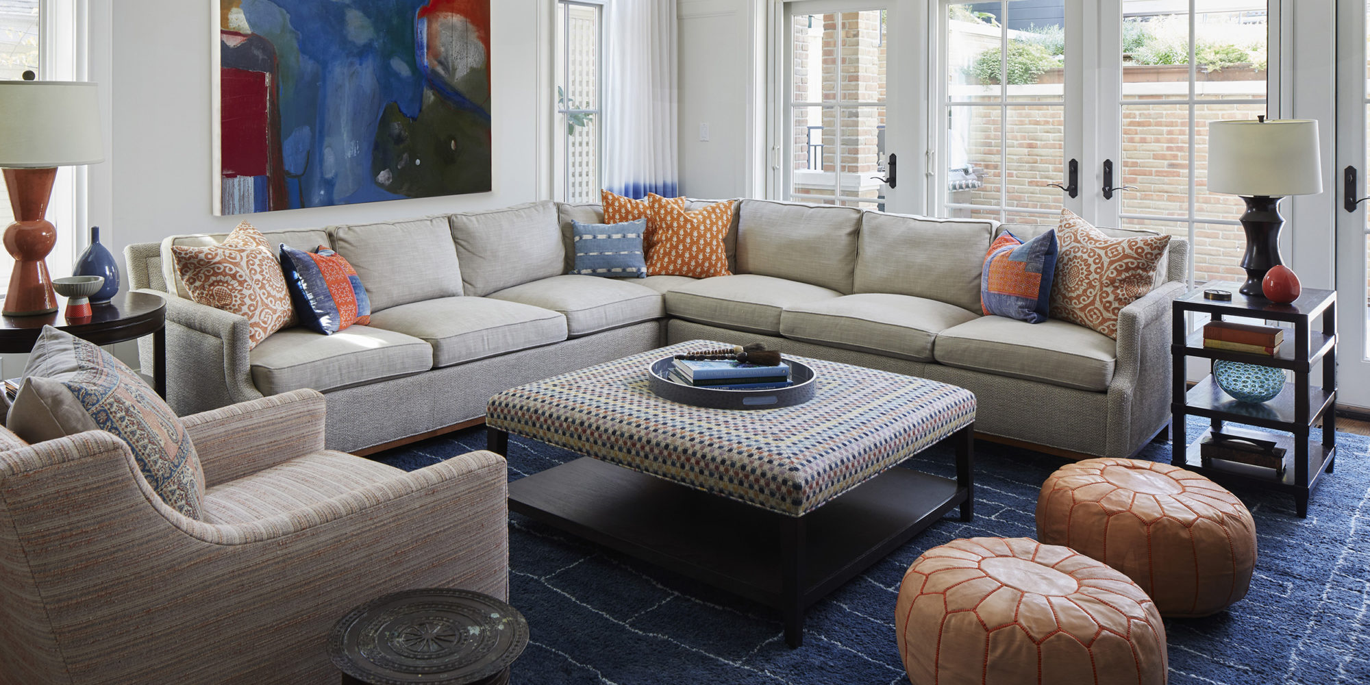Fun and Vibrant family room incorporates Sectional Sofa, Upholstered Coffee Table using Osborne and Little Fabric, and Charles Stewart Company Lounge Chairs.