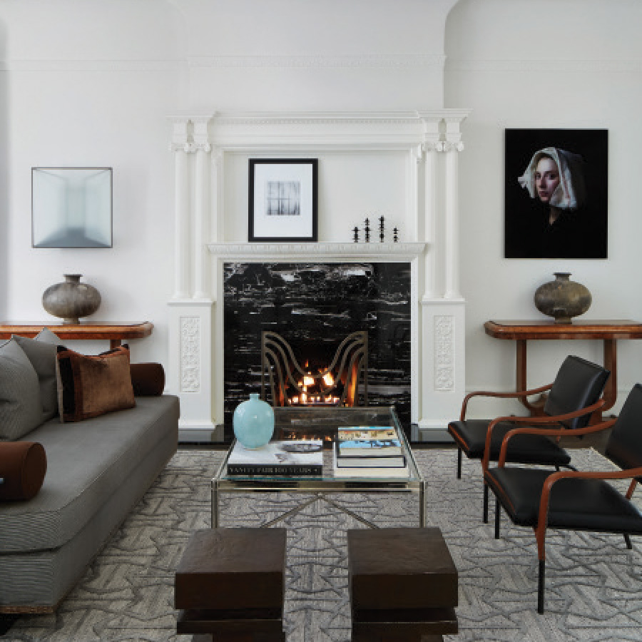 Living Room incorporates black marble fireplace, SHIIR Rug, antique chrome and glass coffee table, and wooden console tables.