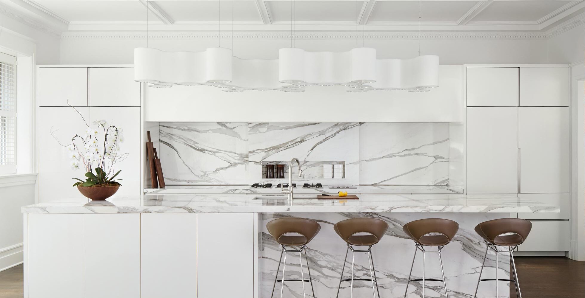 Bright and Airy Kitchen incorporates cumulus fixture by Ted Amramczyk, and Janus et Cie counterstools.