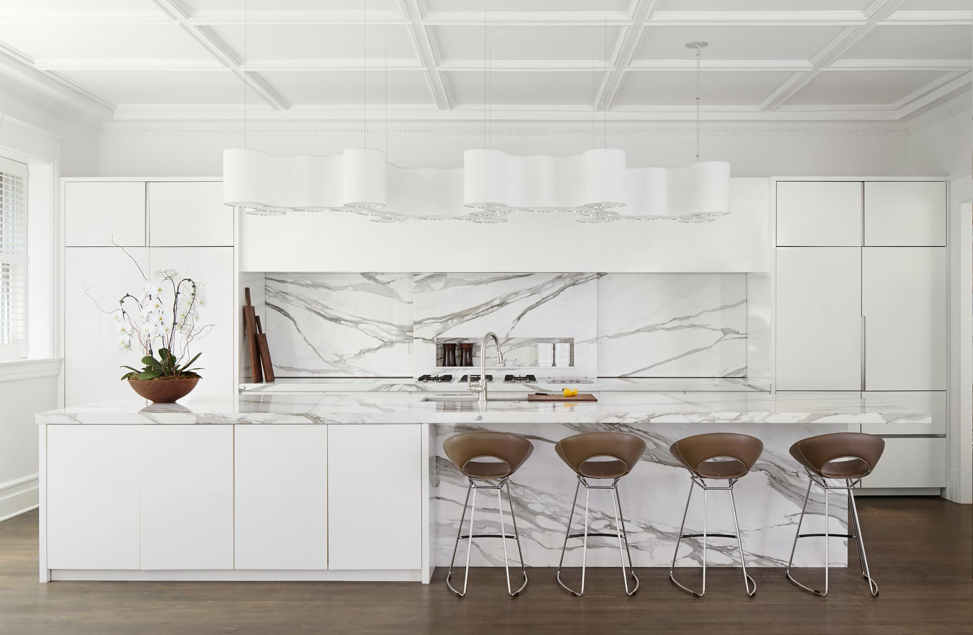 Bright and Airy Kitchen incorporates cumulus fixture by Ted Amramczyk, and Janus et Cie counterstools.