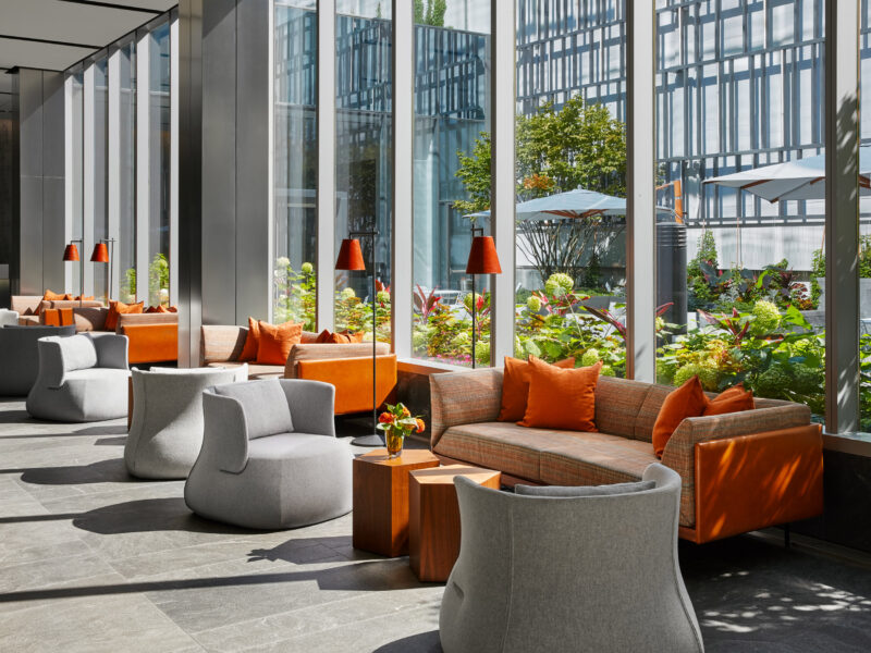 Indoor Work and Lounge Area including vibrant orange sofas and club swivel chairs