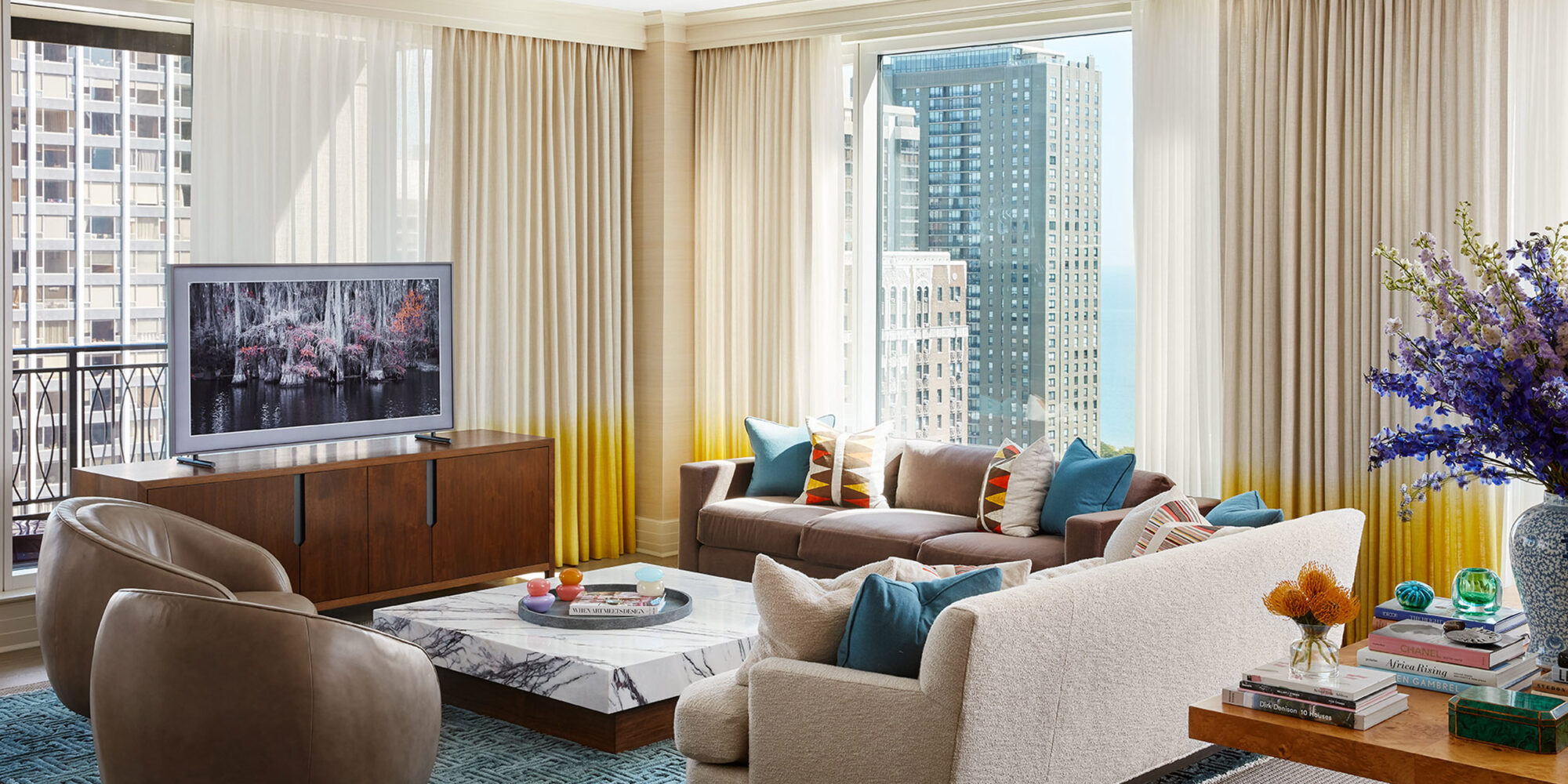 Living Room Design incorporating sofas, media cabinet, Kelly Wearstler swivel chairs, and Kyoto Rug by SHIIR
