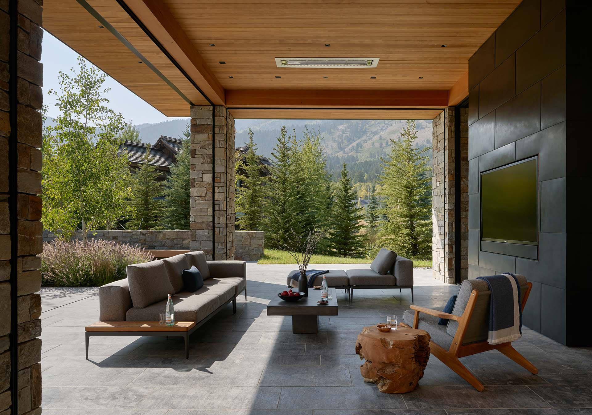 Spacious Patio Overlooking the Mountains of Jackson Hole with Sofa and Wooden End Tables