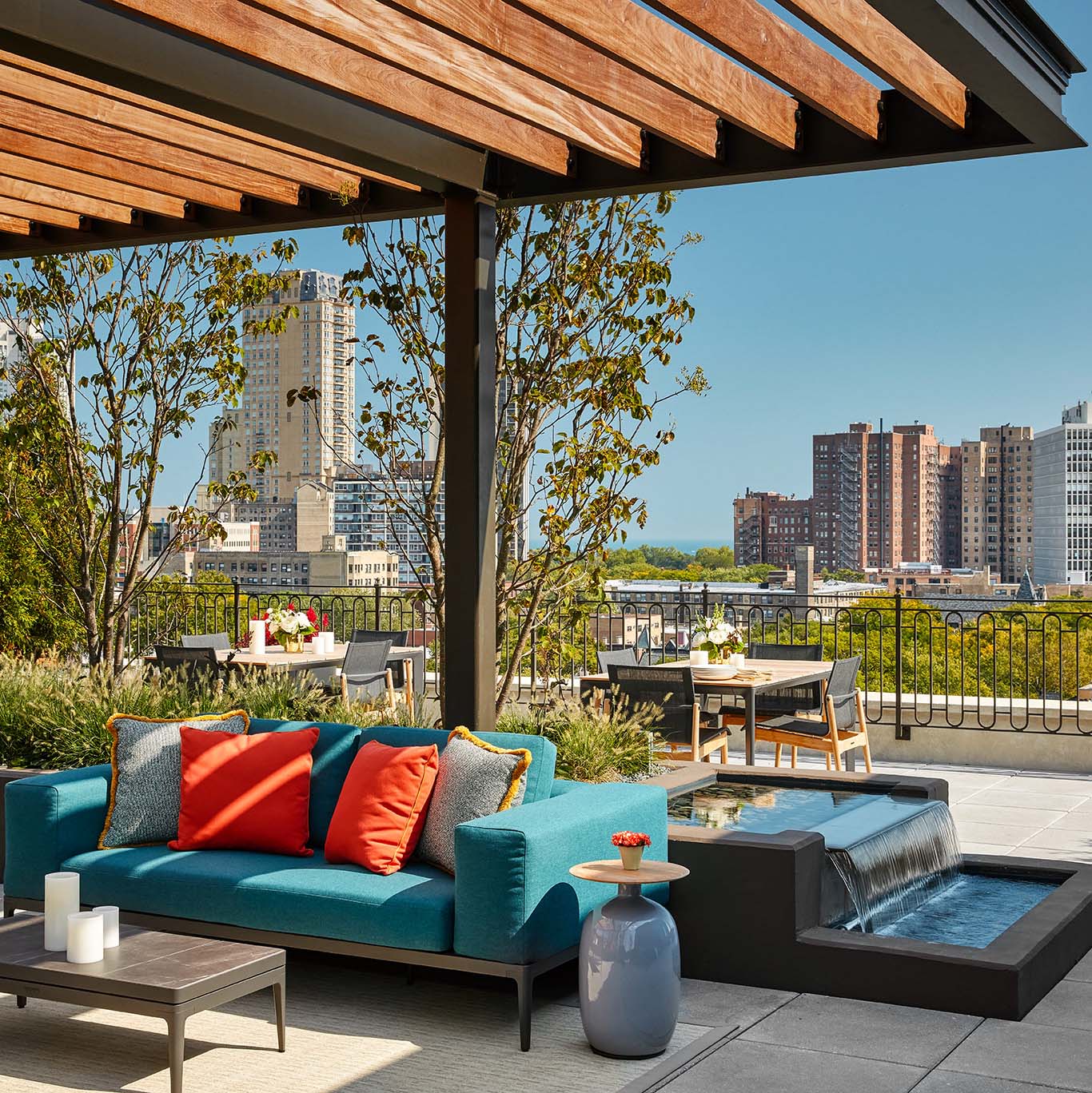 Large Communal Rooftop Deck with Bright Couches and Fountain